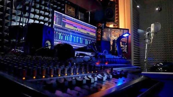 Recording studio mixing console and vocal booth with mood lighting